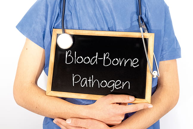 Caucasian doctor shows information on blackboard: blood-borne pathogen. 